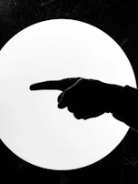 A stylized red shadow figure pointing towards a glowing link icon.