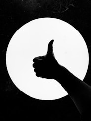 persons hand on white round board