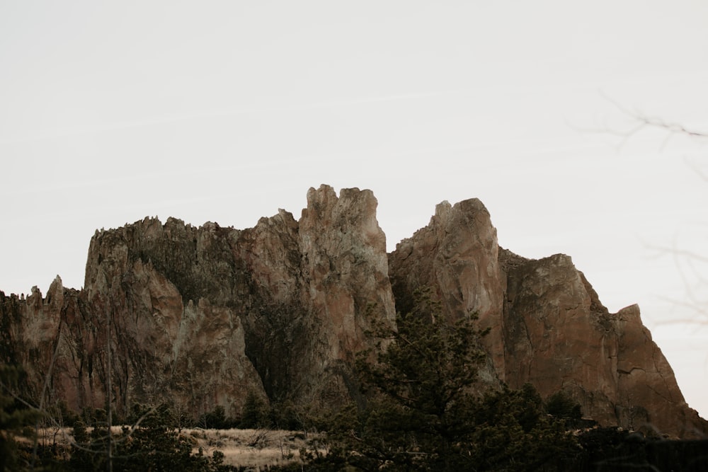 brown rock formation under white sky during daytime