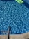 Clear blue water ripples in a swimming pool with a shiny metal ladder at the pool's edge and a green inflatable float on the water surface.