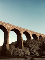 brown concrete bridge under blue sky during daytime