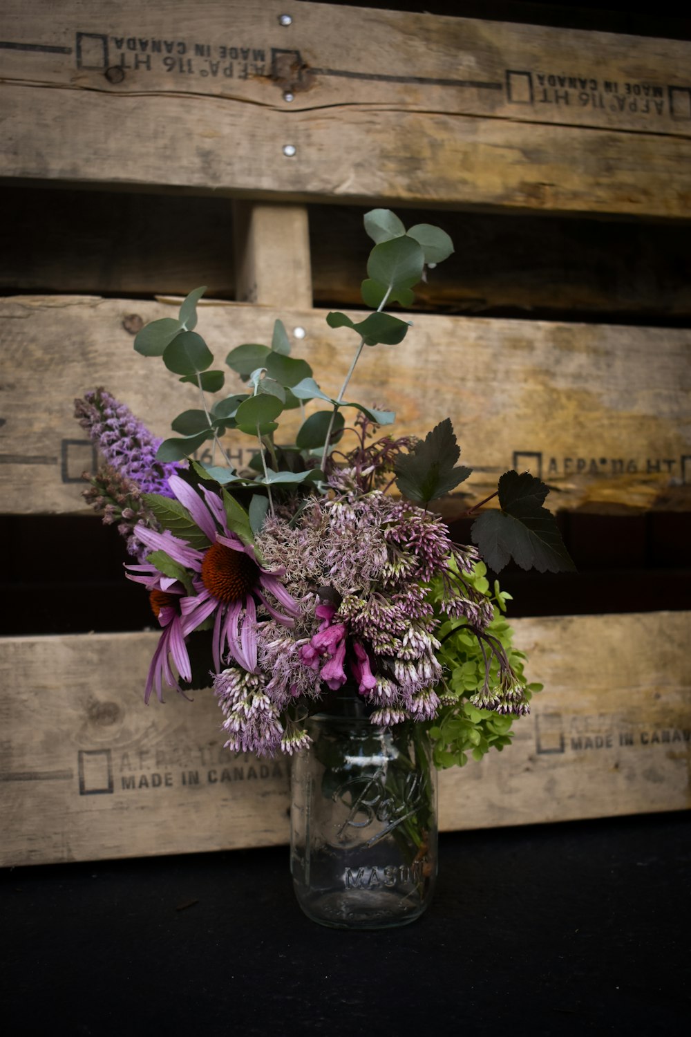 purple flowers in clear glass vase