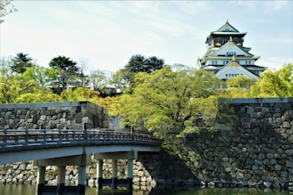 white and black concrete building near green trees during daytime