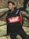 man in black and red adidas jacket wearing black headphones