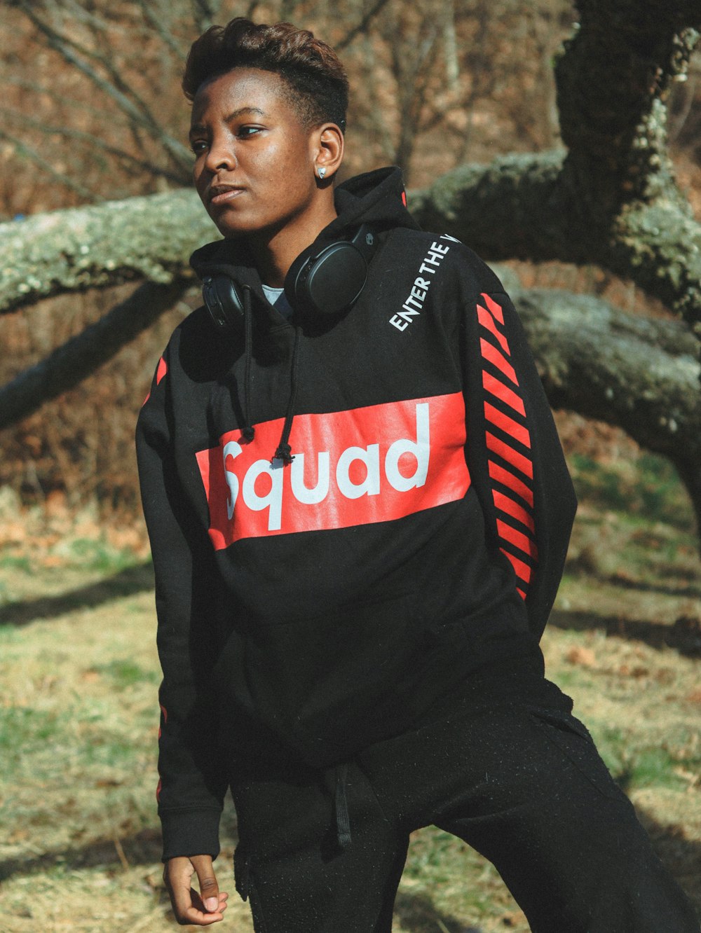 man in black and red adidas jacket wearing black headphones