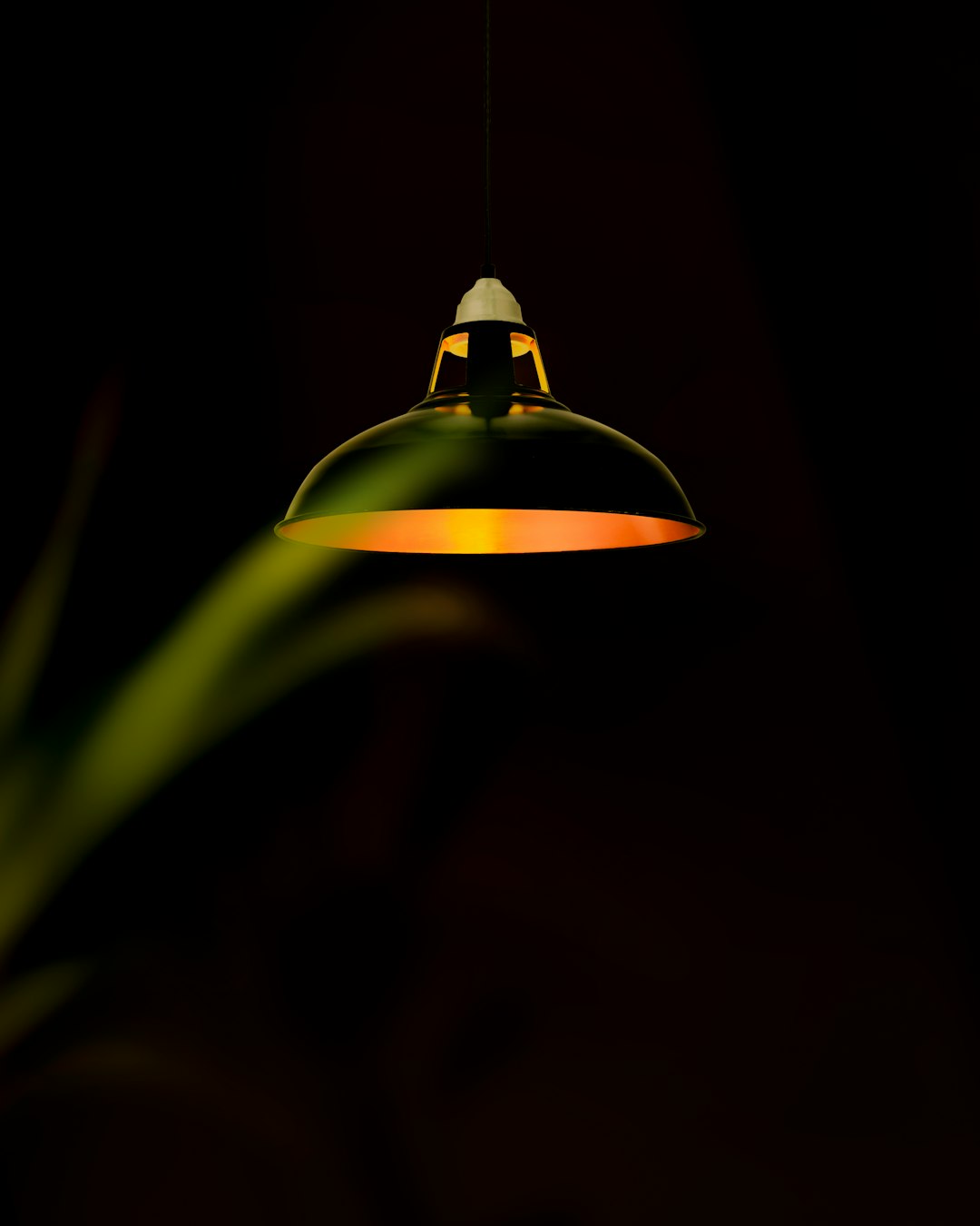 green pendant lamp turned on in dark room