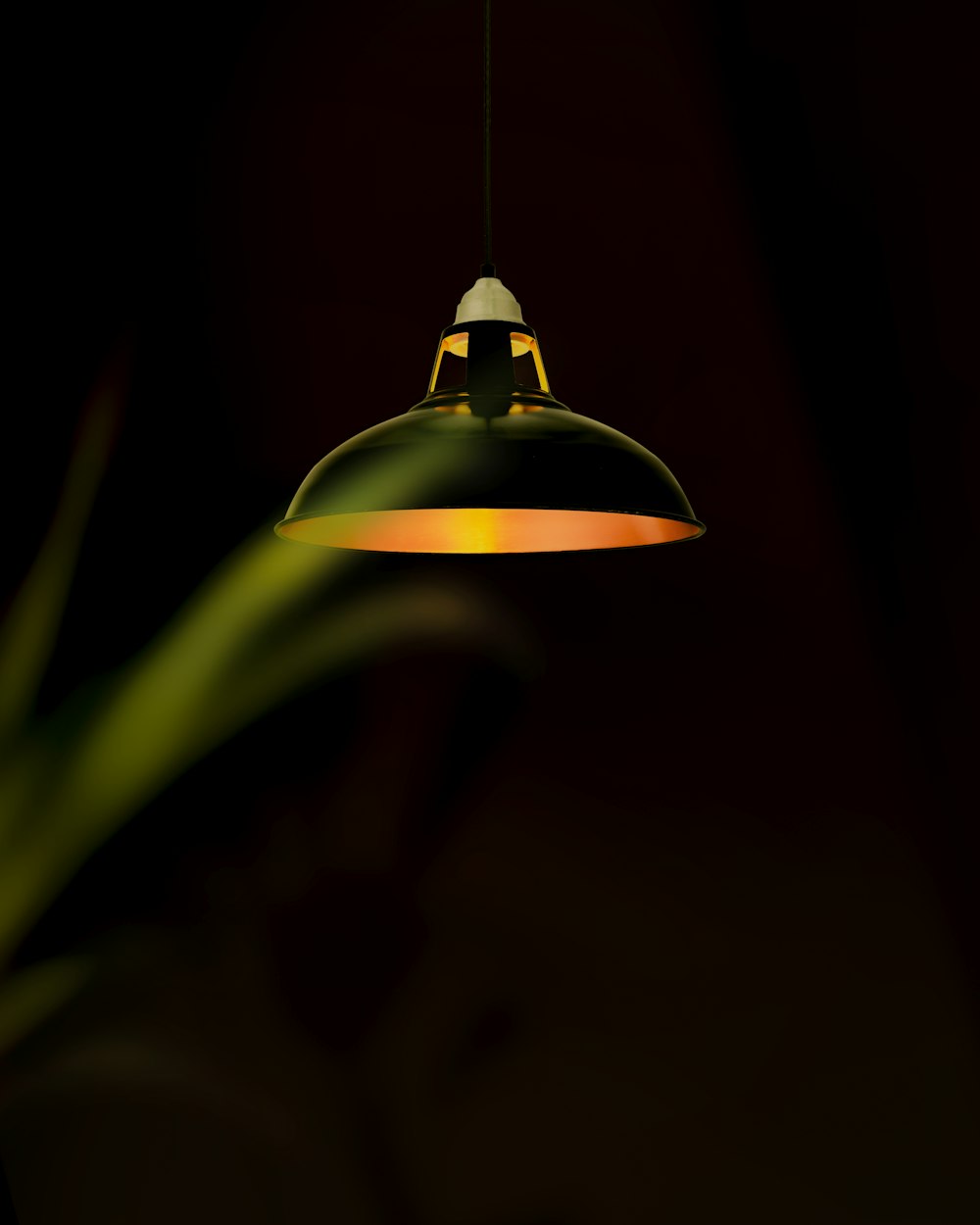 green pendant lamp turned on in dark room