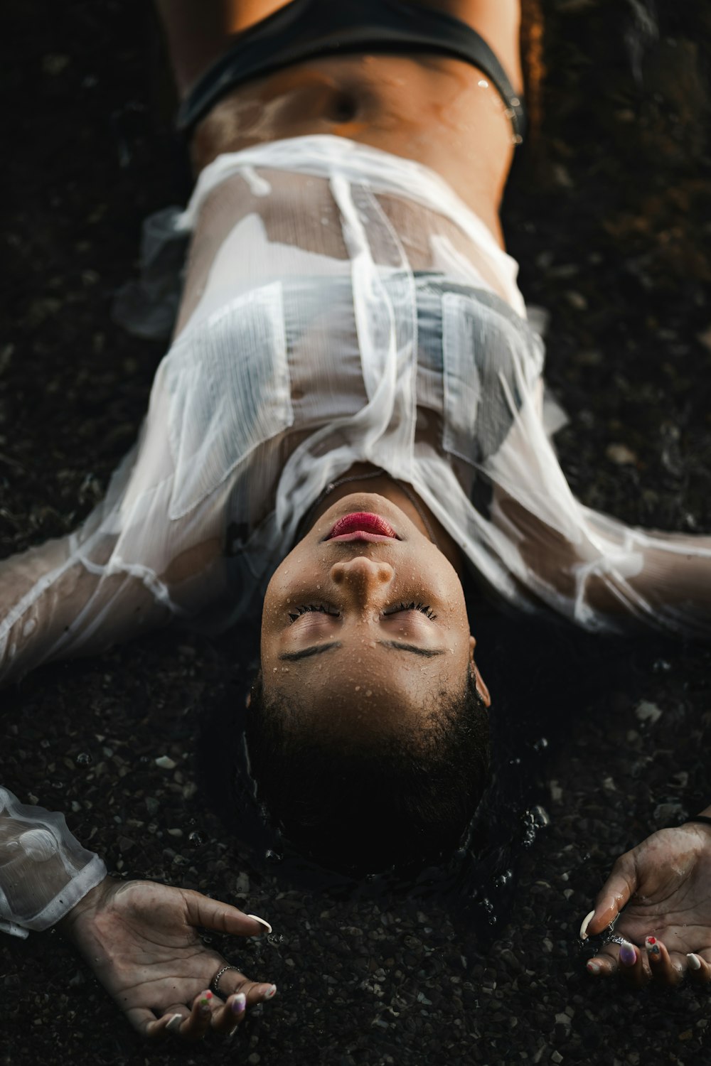 man in white shirt lying on ground