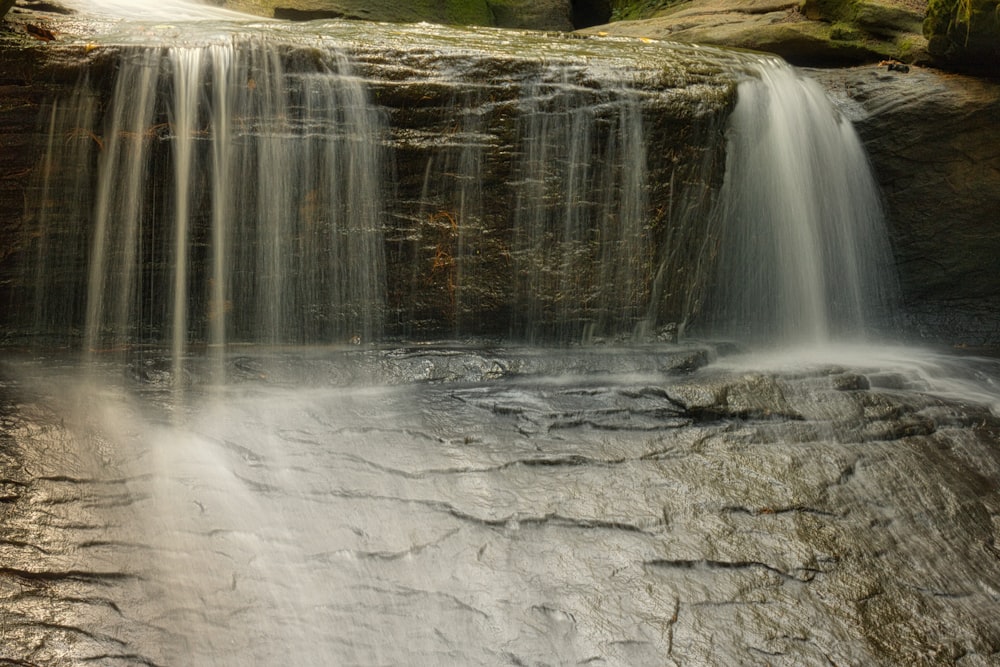 water falls on gray rock