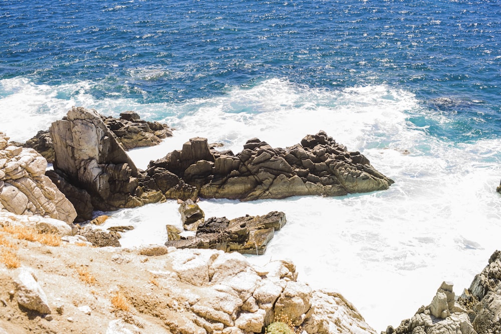 brown rock formation on sea shore during daytime