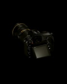 black dslr camera on white surface