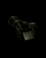 black dslr camera on white surface