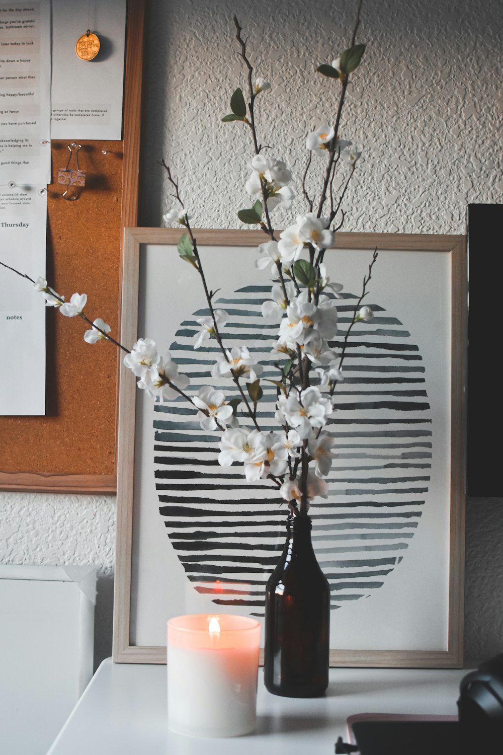 white flowers on black glass vase