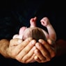 person holding babys hand