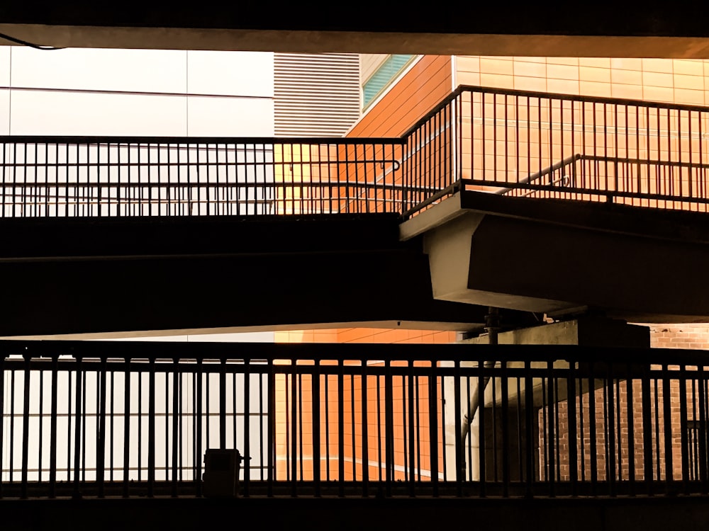 brown wooden staircase with black metal railings