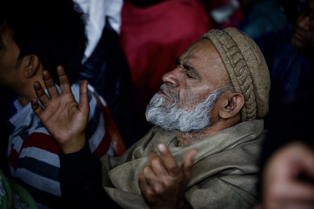 man in brown thobe and white turban