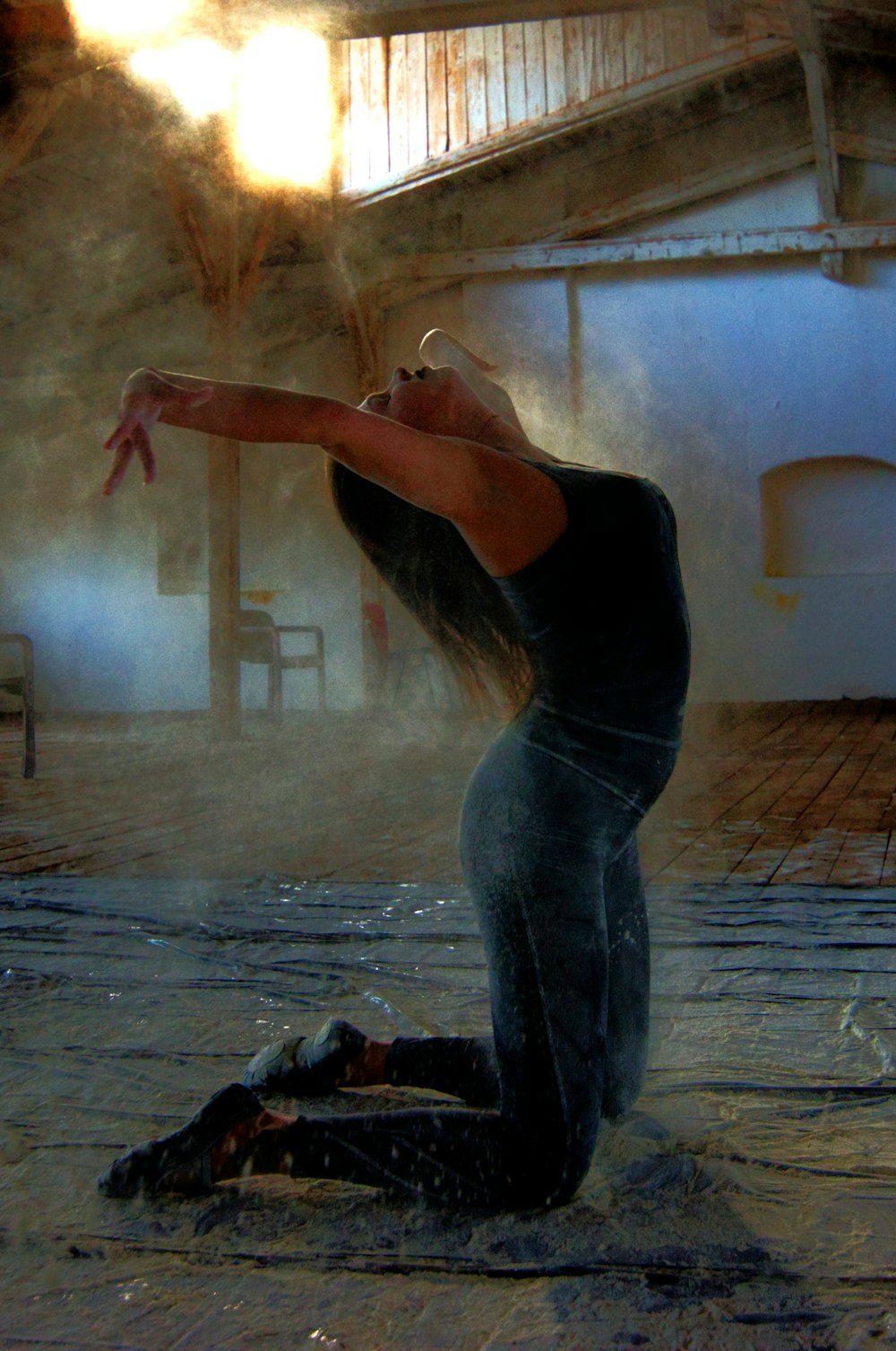 woman in black tank top and blue denim jeans standing on gray concrete floor