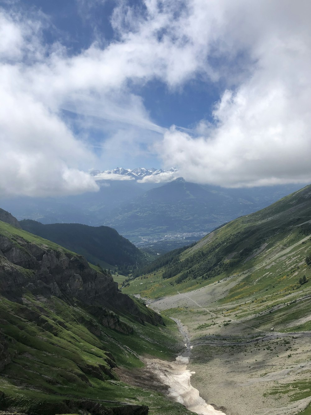 green mountains under white clouds and blue sky during daytime