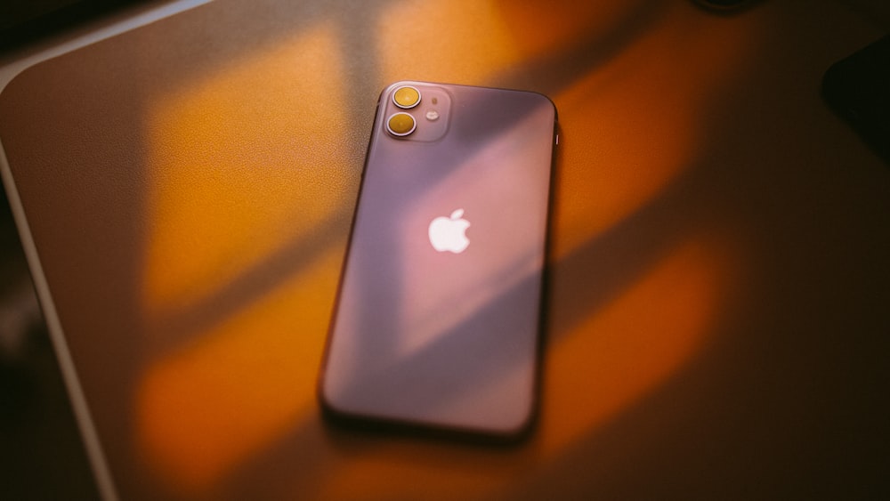 silver iphone 6 on brown wooden table