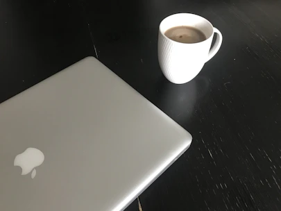 Minimalistic workspace with laptop and coffee, symbolizing efficient brand-creator connections.