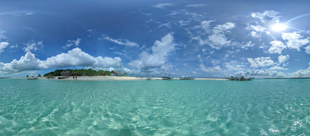 white boat on sea under blue sky and white clouds during daytime