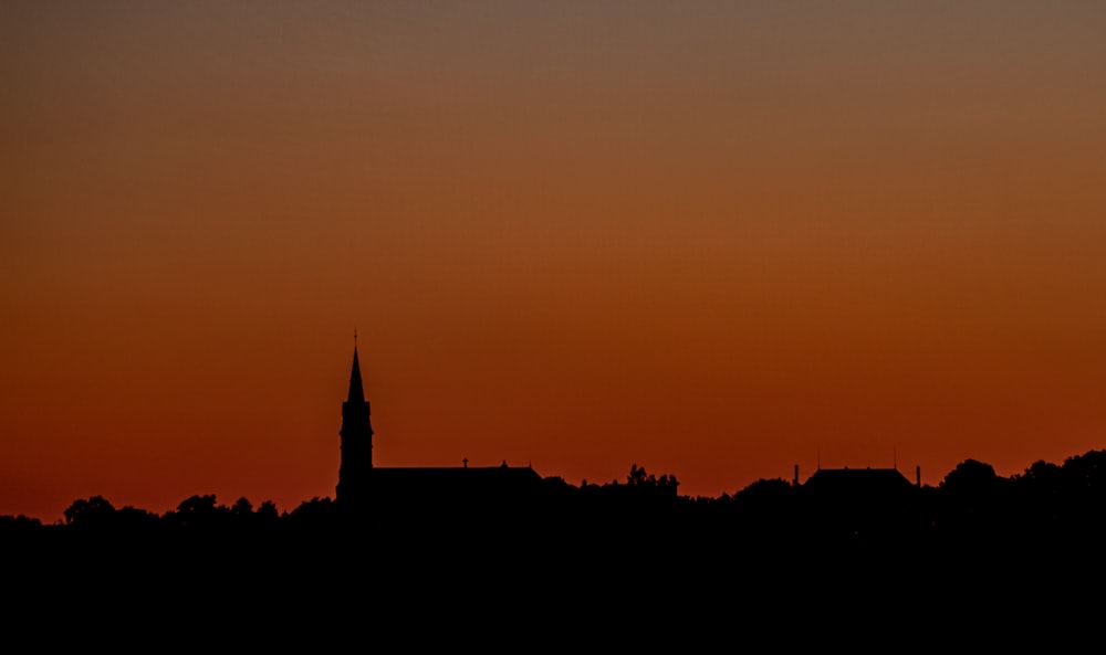 silhouette of building during sunset