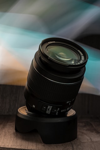 black camera lens on brown wooden table