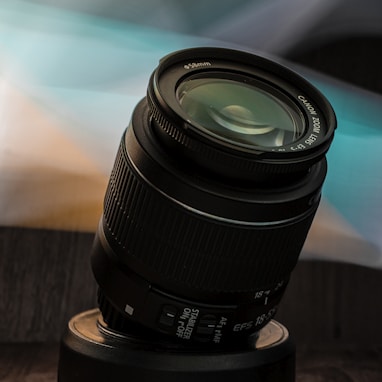 black camera lens on brown wooden table