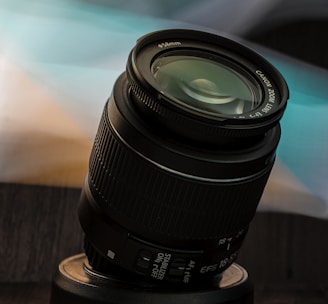 black camera lens on brown wooden table