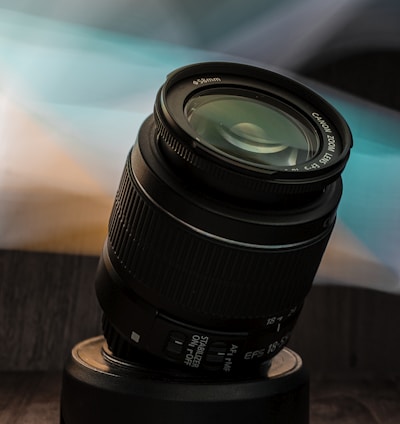 black camera lens on brown wooden table