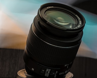 black camera lens on brown wooden table