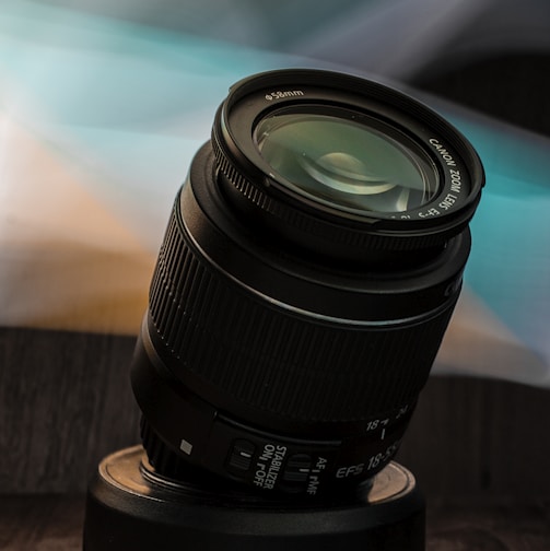 black camera lens on brown wooden table