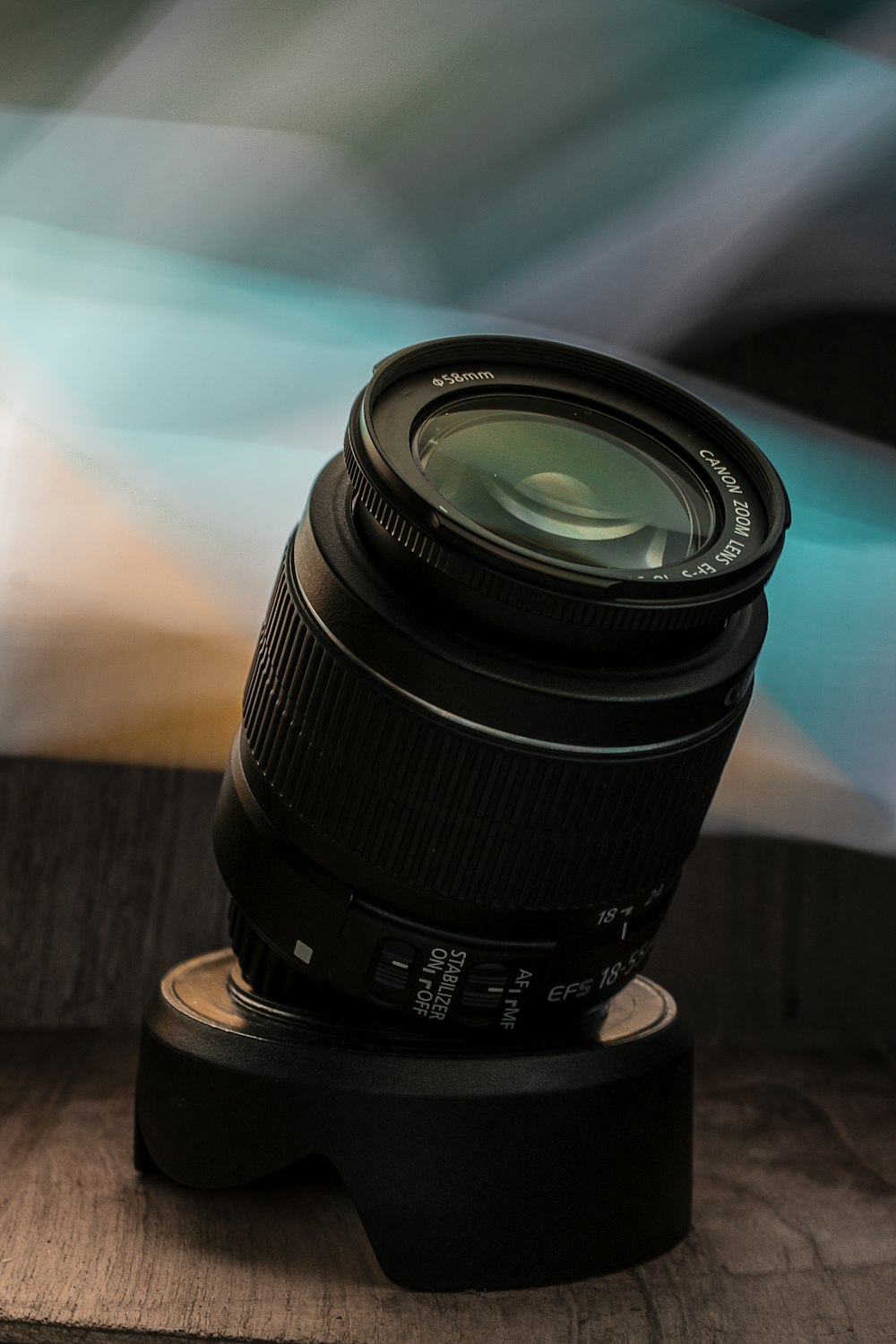 black camera lens on brown wooden table