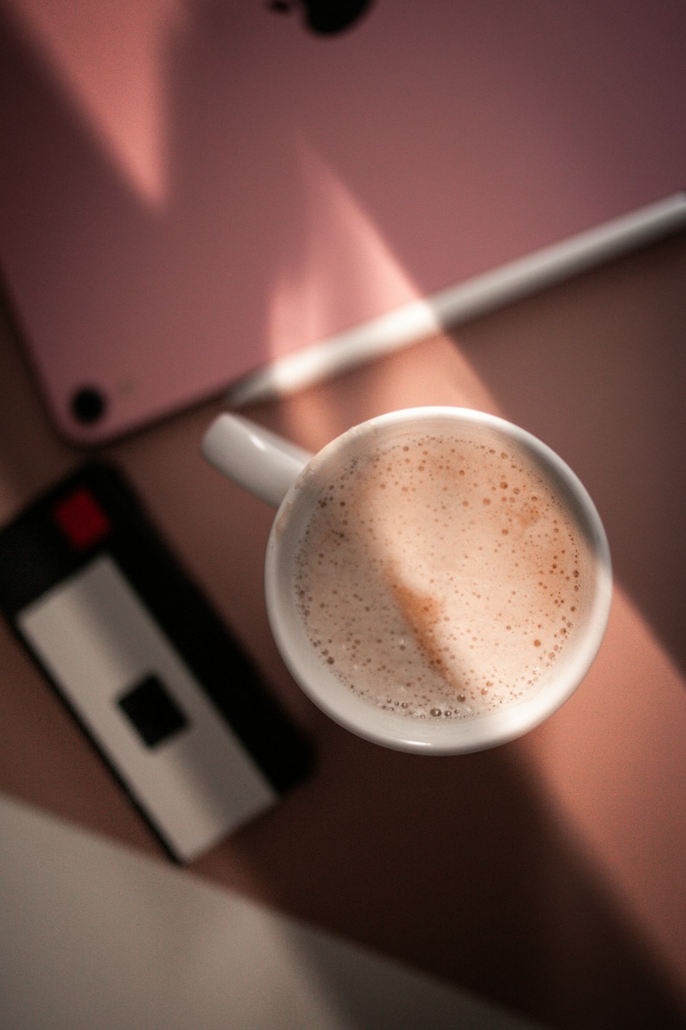 white ceramic mug with brown liquid