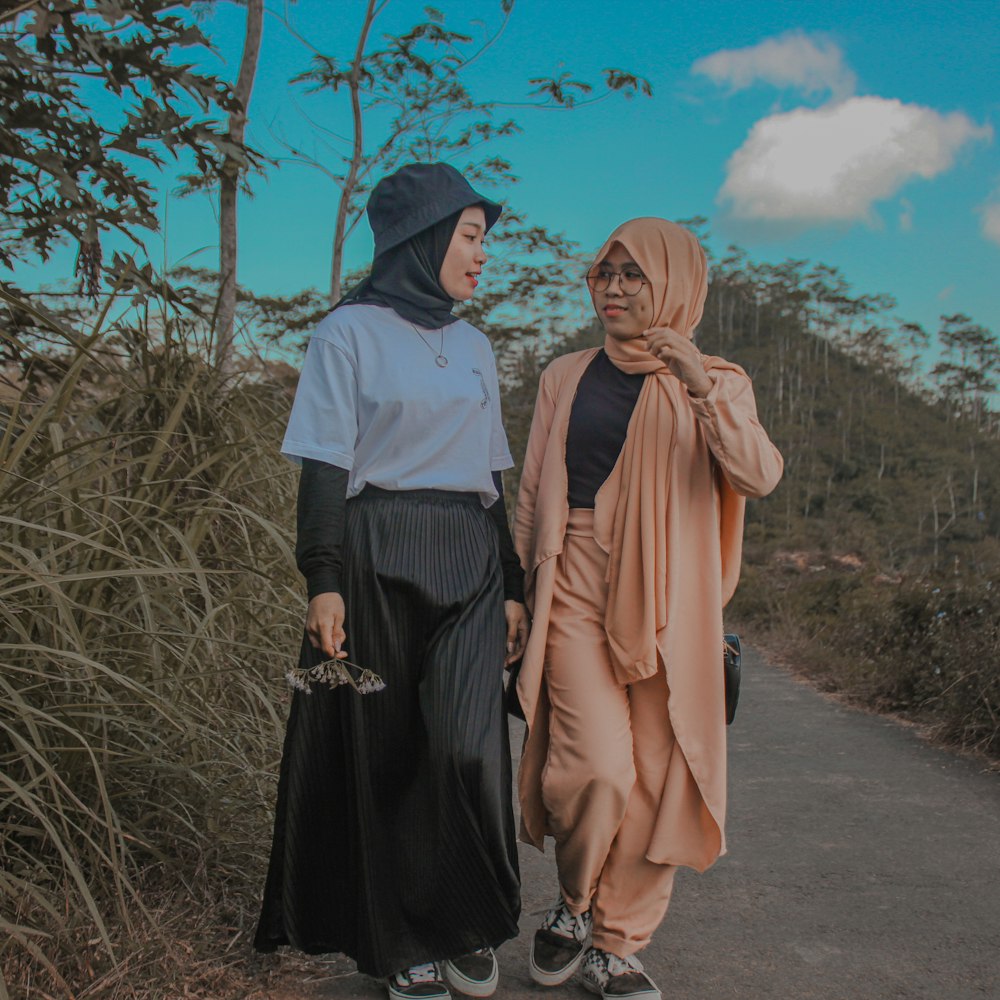 man and woman standing on road during daytime