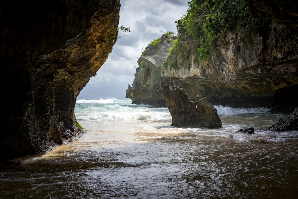 brown rock formation near body of water during daytime