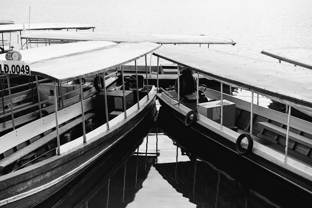 grayscale photo of white and black boat on water