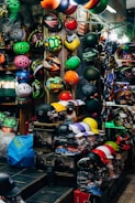 Display of helmets, locks, and chargers neatly arranged on store shelves.