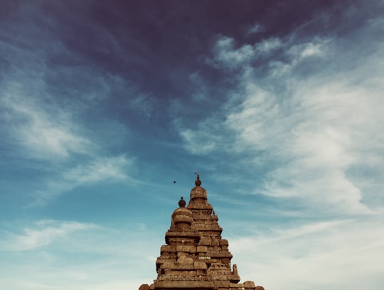 brown concrete structure under blue sky in Group of Monuments at Mahabalipuram India