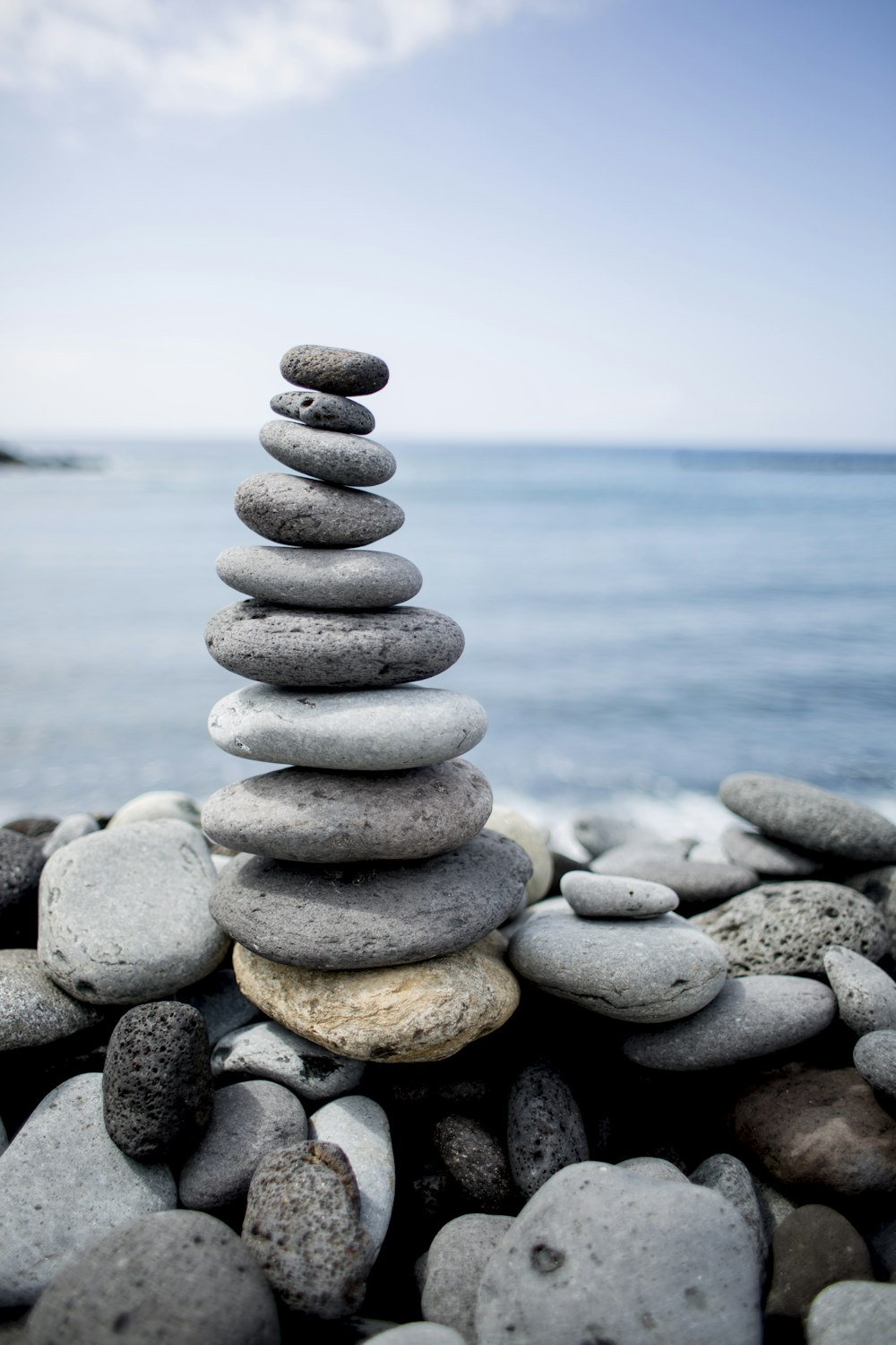 stack of gray stones near body of water during daytime