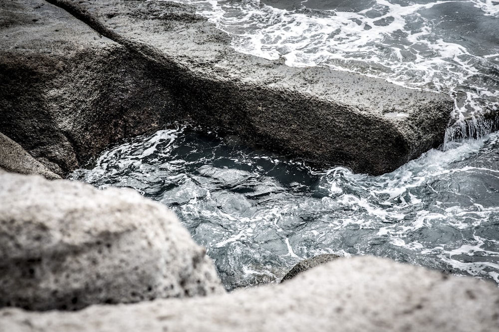 brown rock formation near body of water during daytime