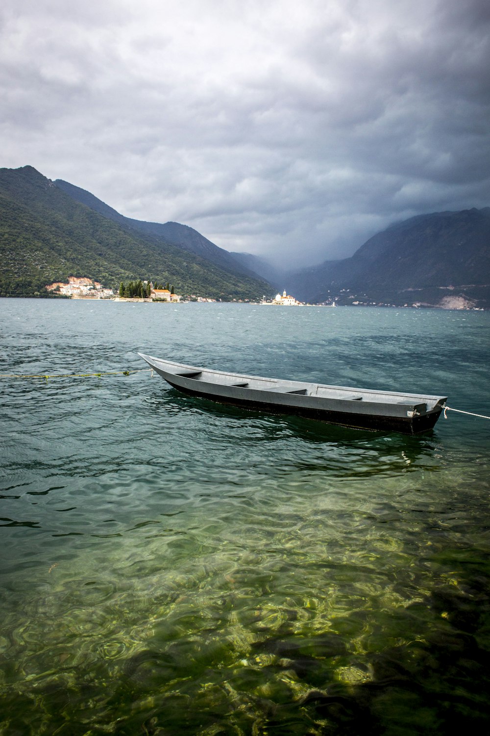 white and black boat on body of water during daytime