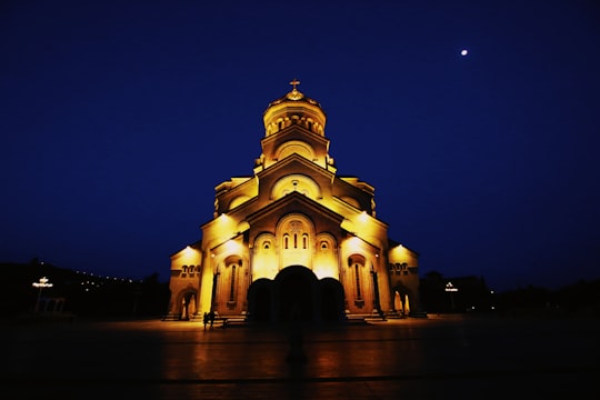 brown concrete building during night time in Tbilisi St. Trinity Cathedral Georgia