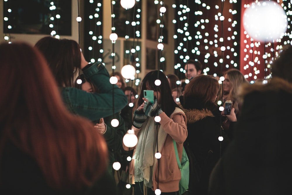 people standing and walking on street during night time