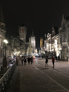 A serene Vienna street scene with travelers walking past historic architecture in the early evening.