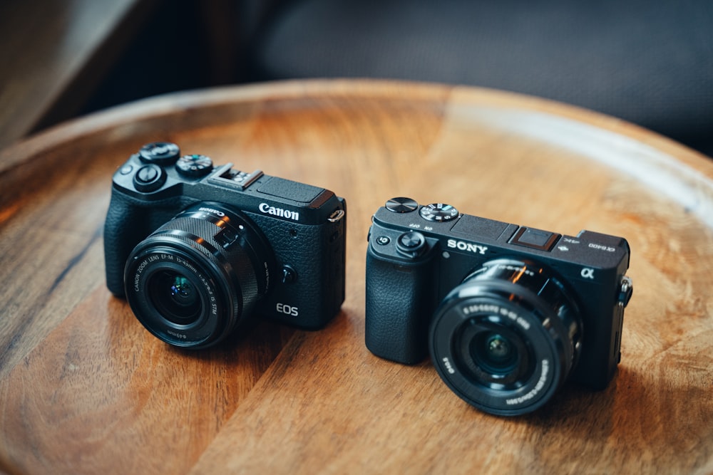 black nikon dslr camera on brown wooden table