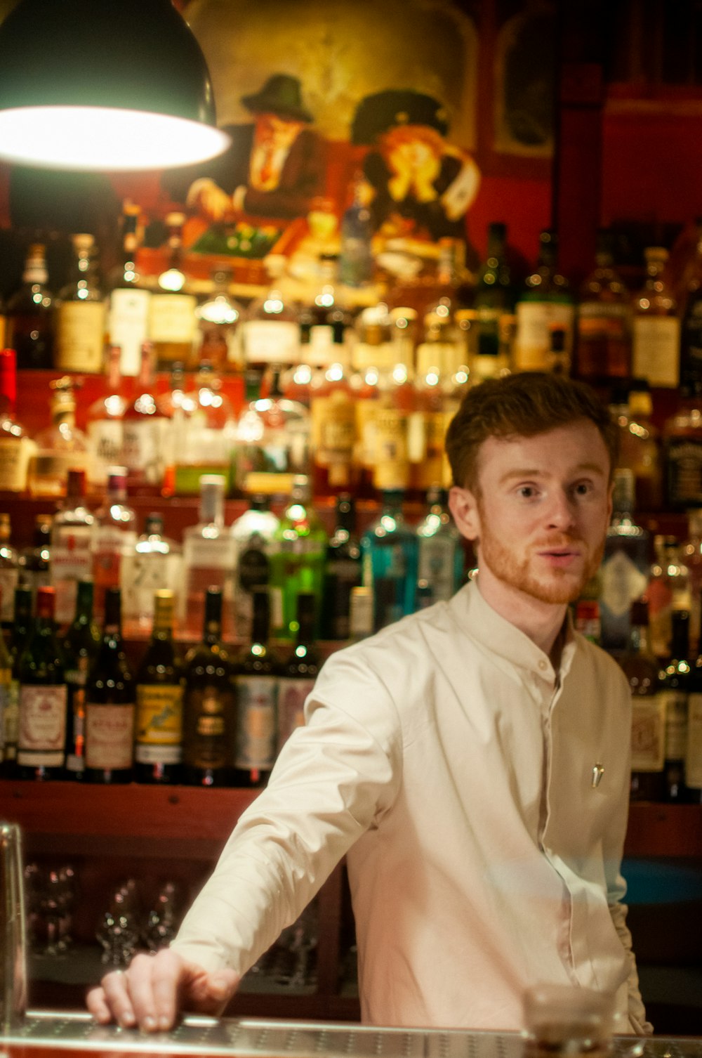 man in white dress shirt sitting on bar counter