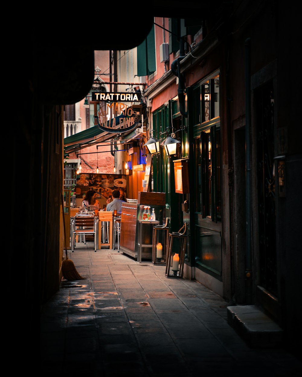 brown wooden chairs and tables on street during daytime