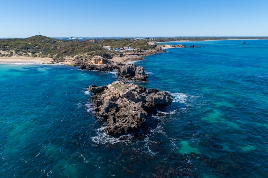 brown rock formation on sea during daytime in Point Peron Road Australia