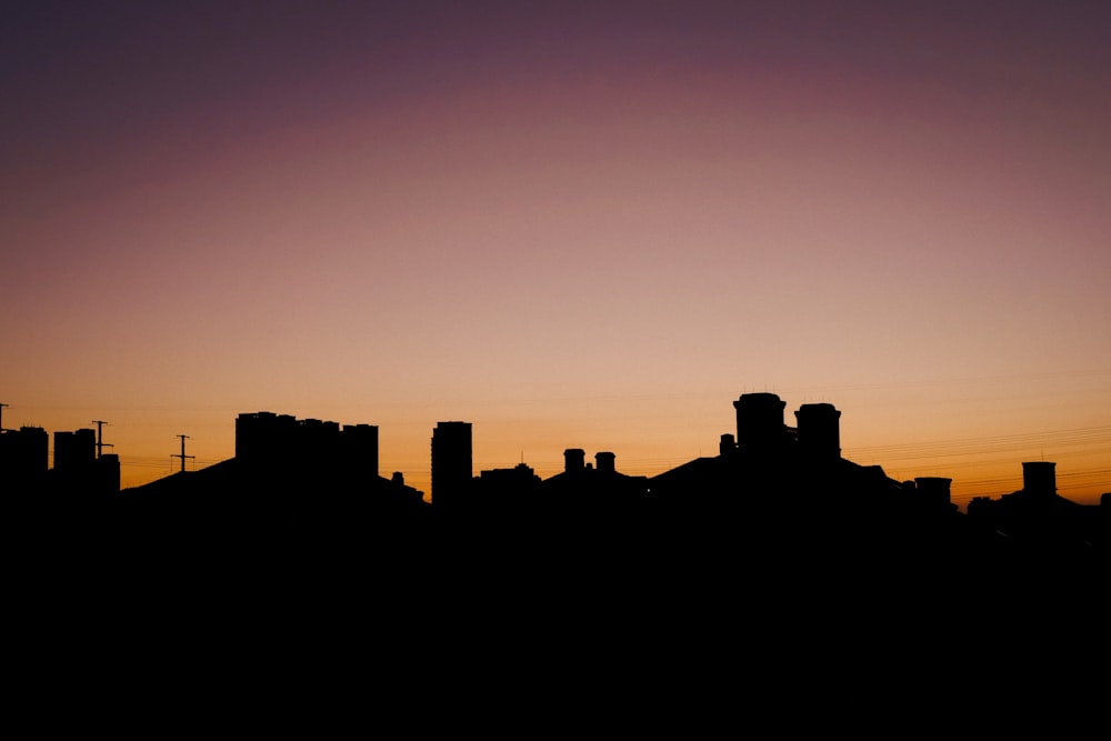 silhouette of city buildings during sunset